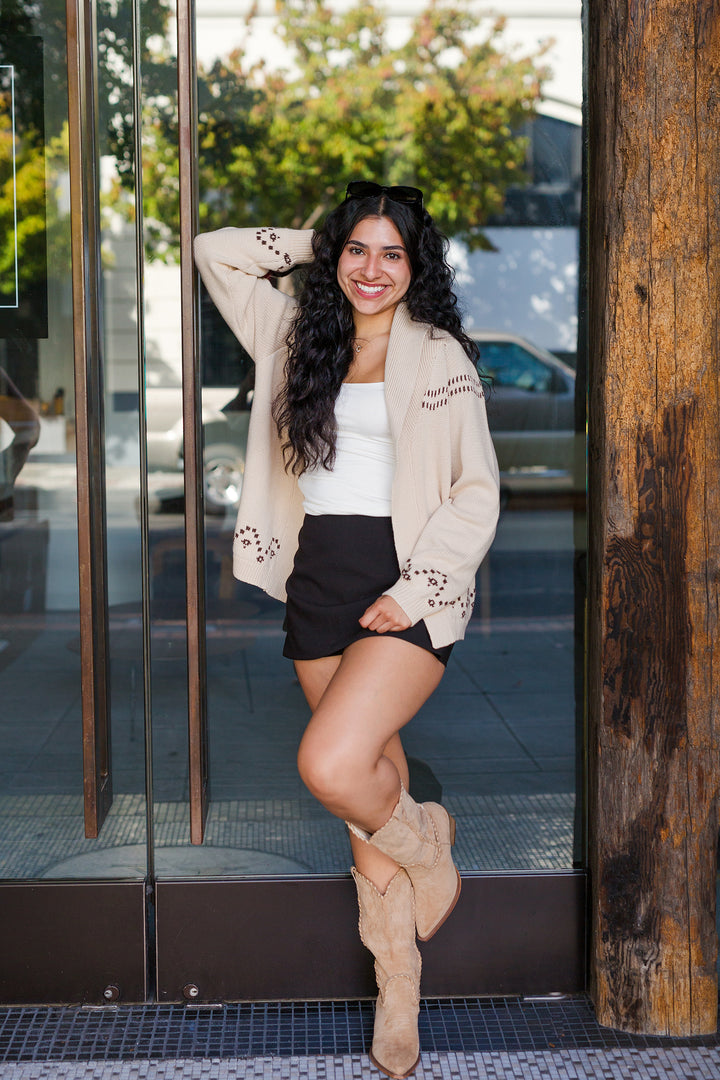Fall sweater with skirt and white tank top. Western suede boots