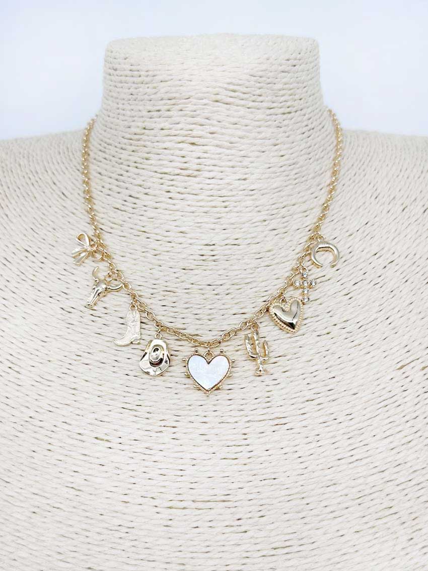 Gold necklace with heart and other charms on a mannequin bust.
