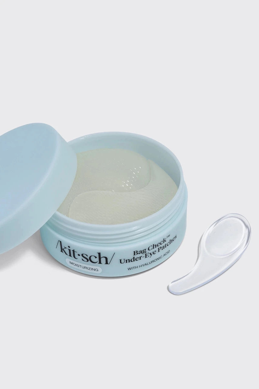 Kit-sch eye cream jar with applicator on a light gray background