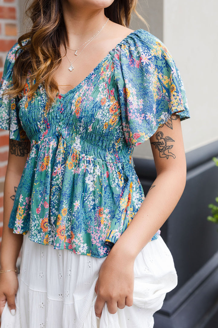 The Fleurs Truly Flutter Sleeve Top